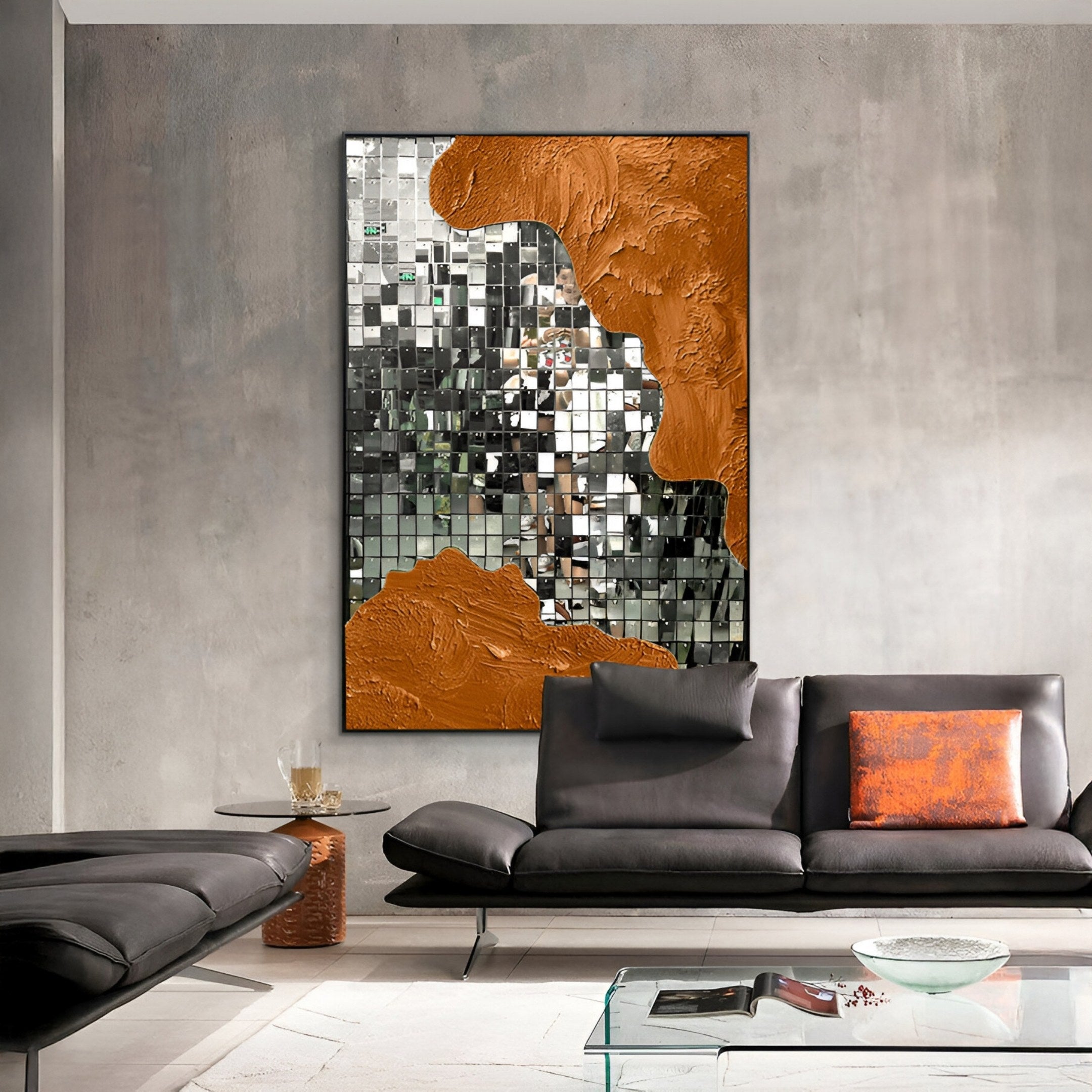 A modern living room with gray walls, a black leather sofa, a glass coffee table, and Giant Sculptures' Miravine Copper Hand-Painted Acrylic Mirror 3D Wall Art featuring bold orange textured accents.