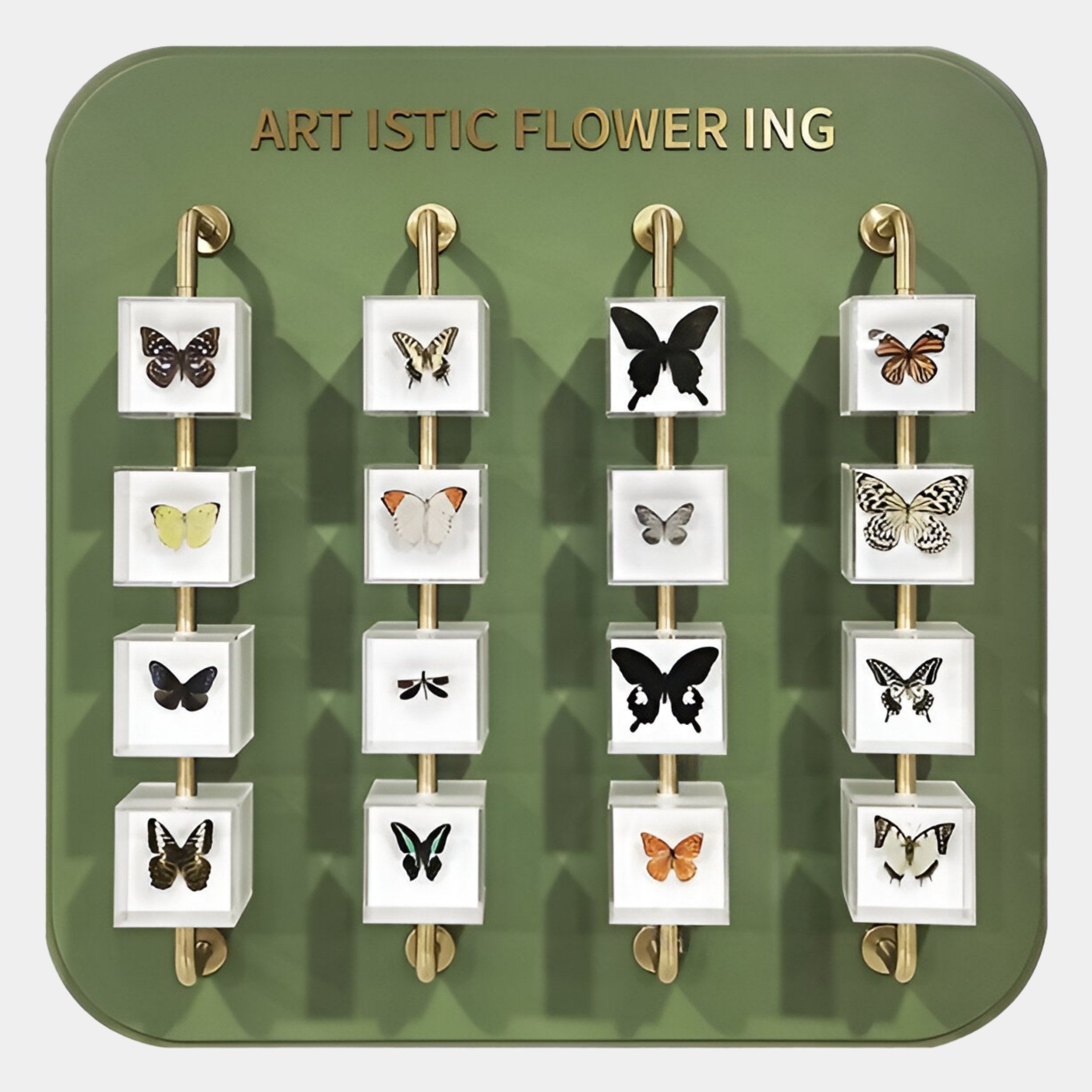 The Aurelian Butterfly Display Acrylic 3D Wall Art by Giant Sculptures features lifelike butterfly specimens on three rods against a green backdrop with gold ARTISTIC FLOWERING text—museum-inspired decor at its finest.