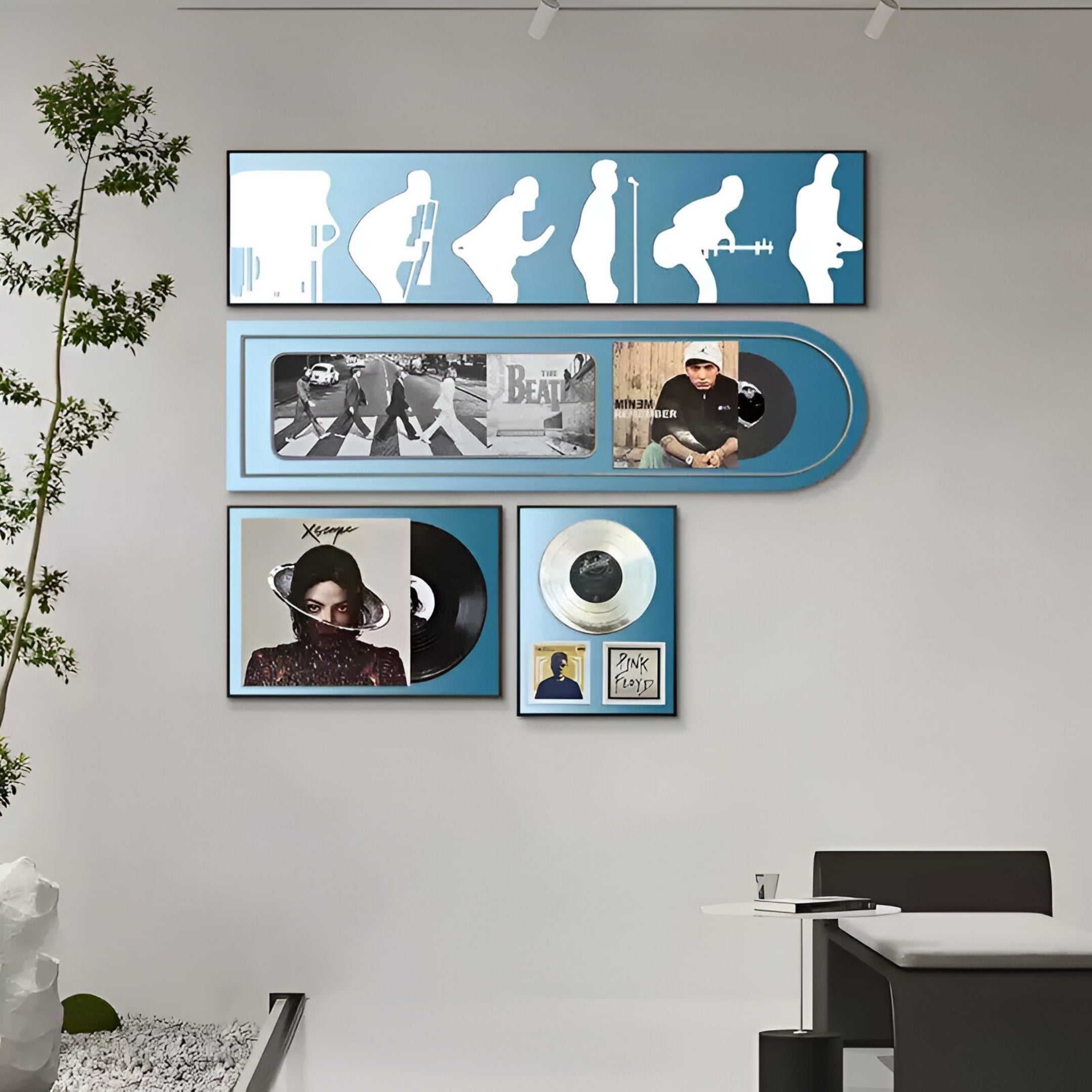 A modern office showcases the Sonarta Blue Multi-Panel Record & Silhouette Wall Art by Giant Sculptures, featuring music-inspired décor with vinyl records and musician silhouettes displayed near a desk and plant.