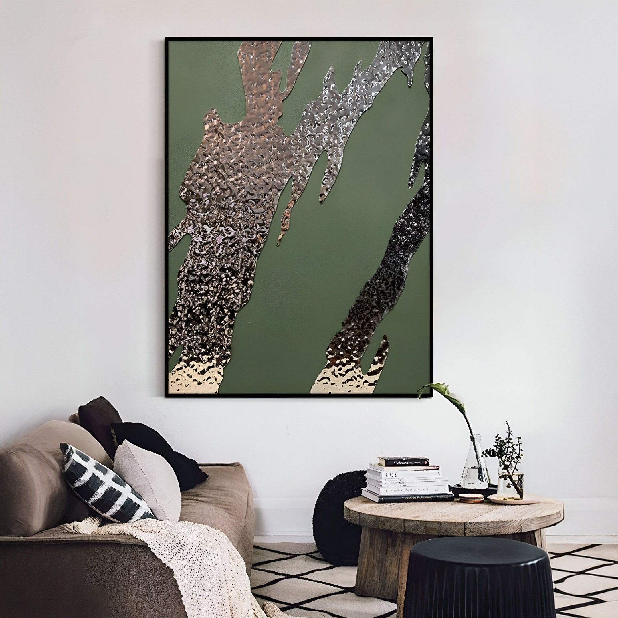 A modern living room with a beige sofa, black and white pillows, a round wooden coffee table with books and a vase, and Giant Sculptures’ Metallura Deep Green Metallic Flow Abstract 3D Wall Art as striking contemporary decor.