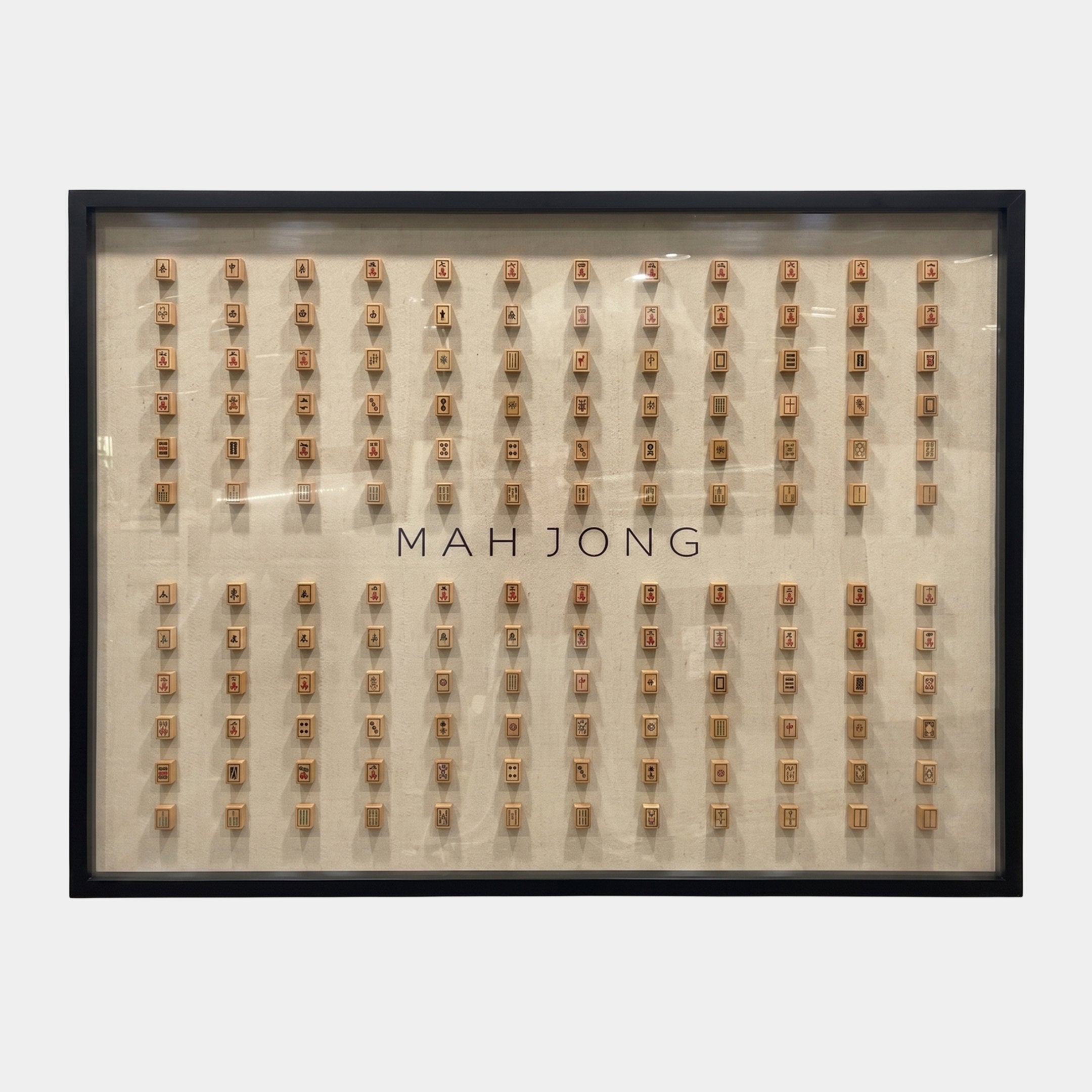 Fortuna Mahjong Carved Wood Tile Linen Wall Art by Giant Sculptures, a landscape grid of real carved wooden mahjong tiles hand-set on natural linen in a slim black glazed frame, with MAH JONG lettering across the centre.