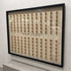 Angled view of the Fortuna Mahjong Carved Wood Tile Linen Wall Art by Giant Sculptures, showing the depth of the black frame and the projection of the mahjong tiles from the linen panel.
