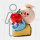 A 160cm-tall Sweet Mischief Apple Pie Labubu Sculpture by Giant Sculptures features a cartoonish figure with a round head, red nose, rosy cheeks on a yellow block holding a large red apple beside a human-height chart.