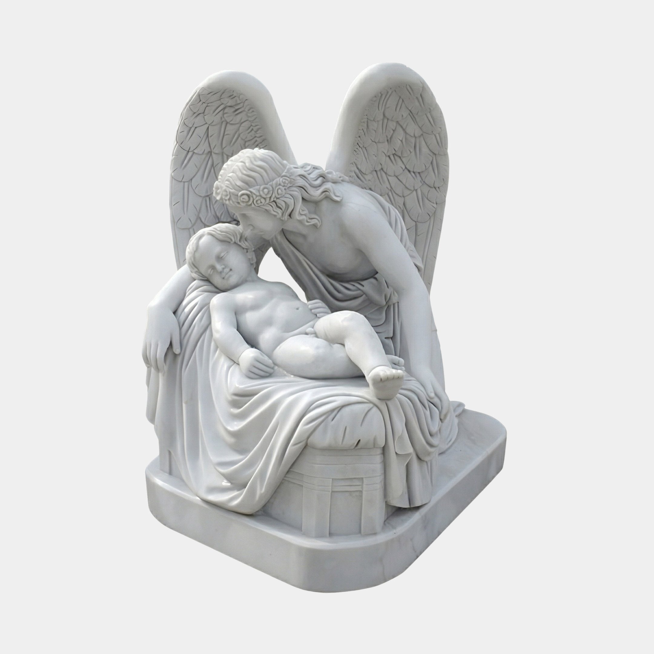 Mother And Son Angel Marble Outdoor Sculpture – 130cm by Giant Sculptures, depicting a winged angel tenderly cradling a sleeping child on draped fabric, carved in white marble on a rectangular base, shown against a plain light grey background.
