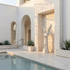 Giant Sculptures Woman Angel Marble Outdoor Sculpture – 180cm white marble angel with spread wings and flowing robes set in a recessed niche beside a courtyard pool.