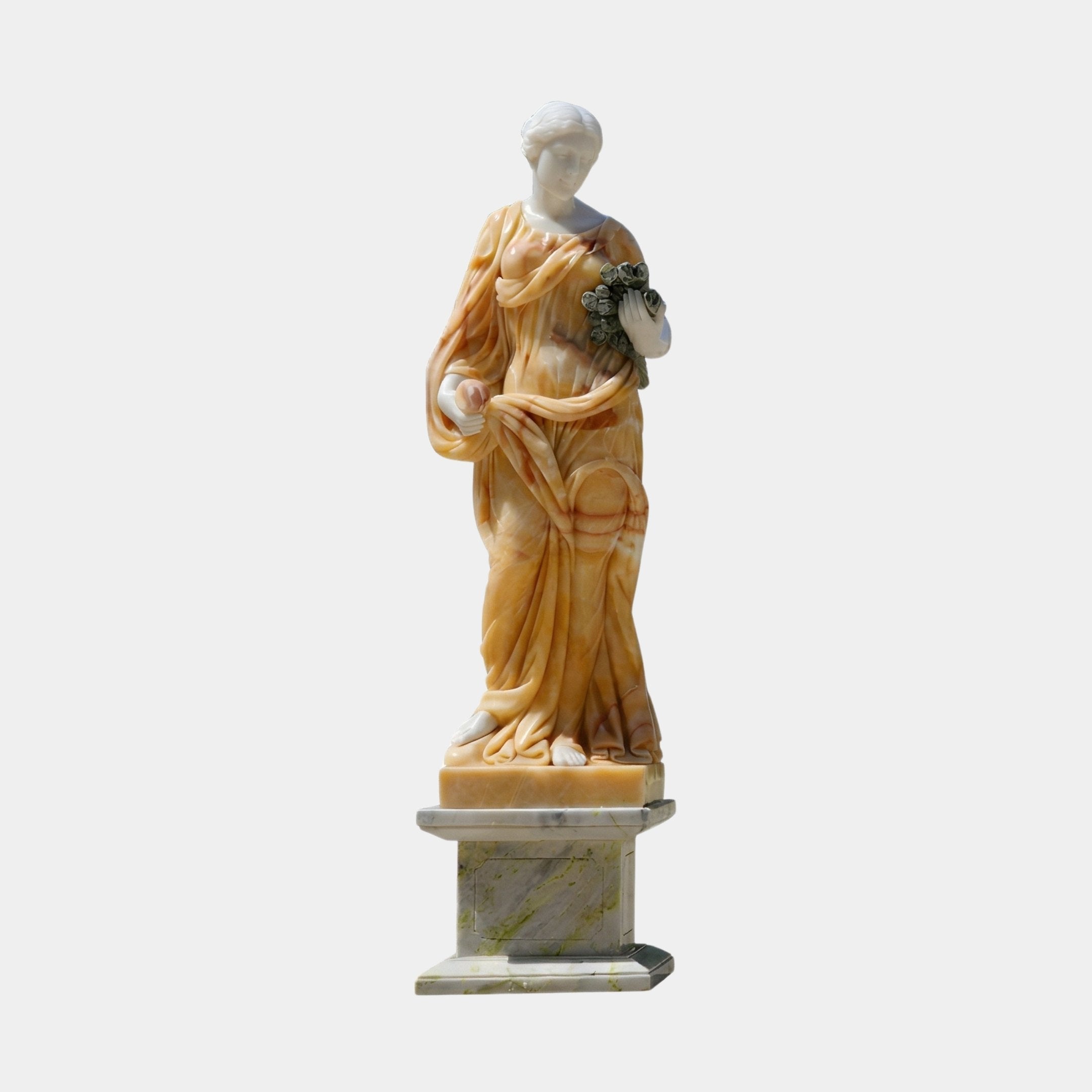 Four Season Female Angel Marble Outdoor Sculpture in warm golden and white two-tone marble, depicting a draped neoclassical female figure holding a floral wreath on a marble pedestal, against a plain light background.