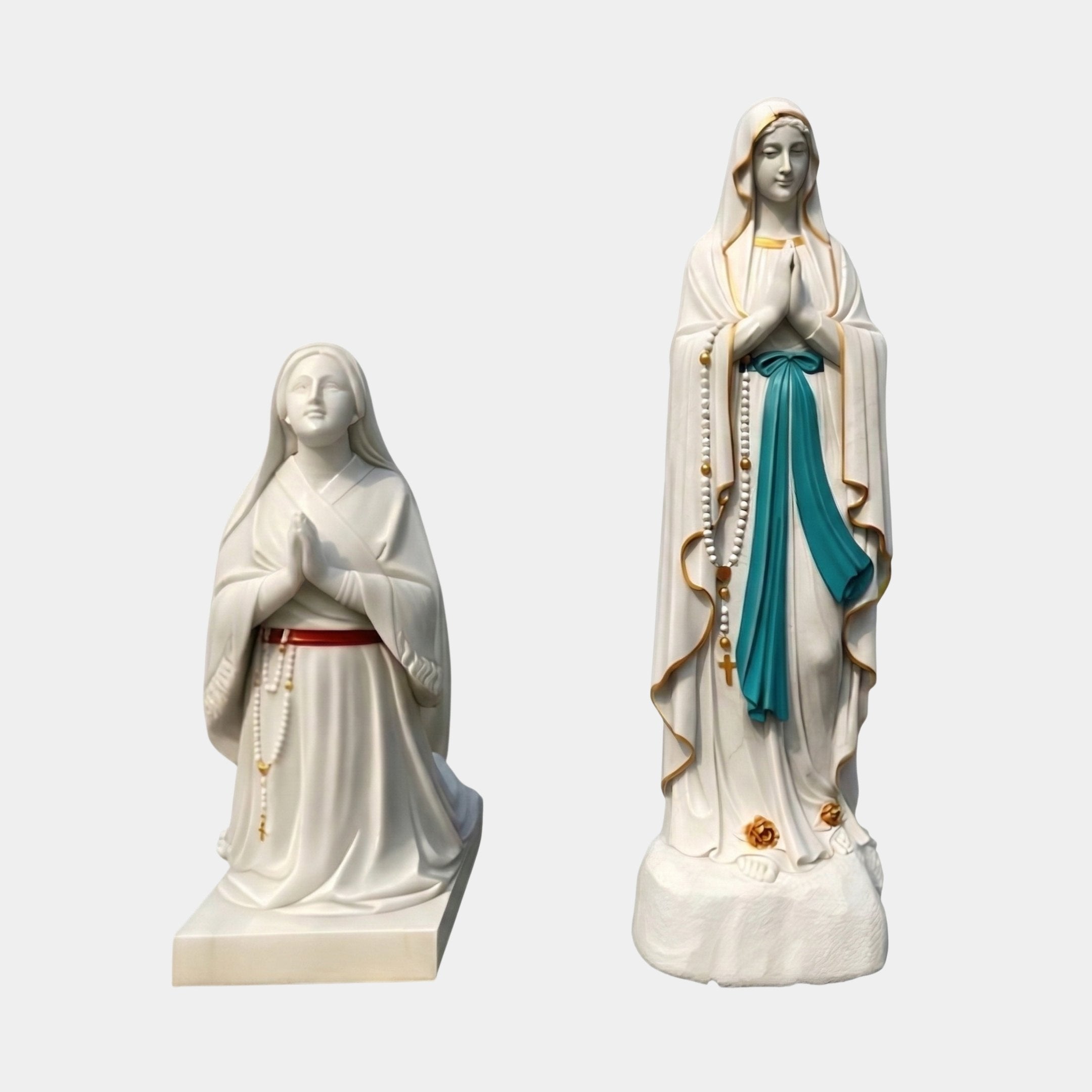 Lourdes Virgin Mary Angel Marble Outdoor Sculpture set showing kneeling Saint Bernadette and standing Our Lady of Lourdes in white marble with painted details, on a plain grey background.