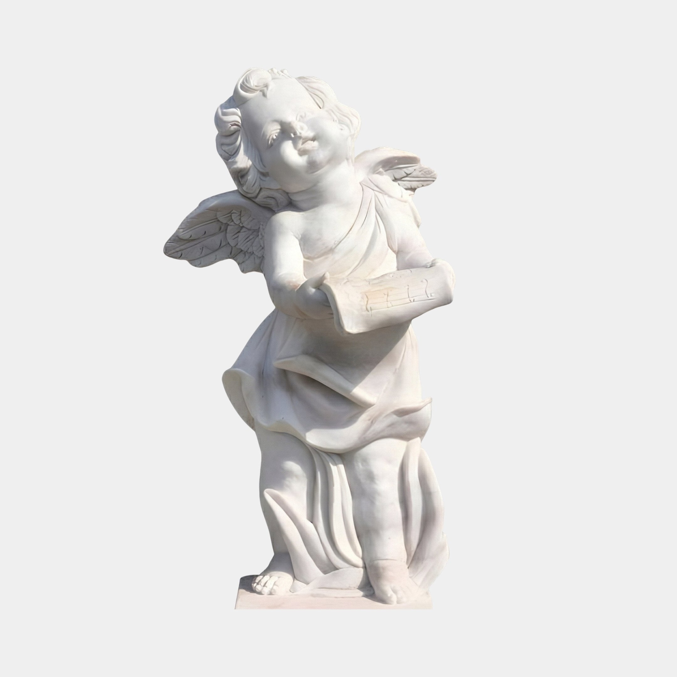 The Little Angel Angel Marble Outdoor Sculpture (60cm) by Giant Sculptures features a smiling cherub with wings, draped garment, and a scroll, crafted in white marble against a plain light background.