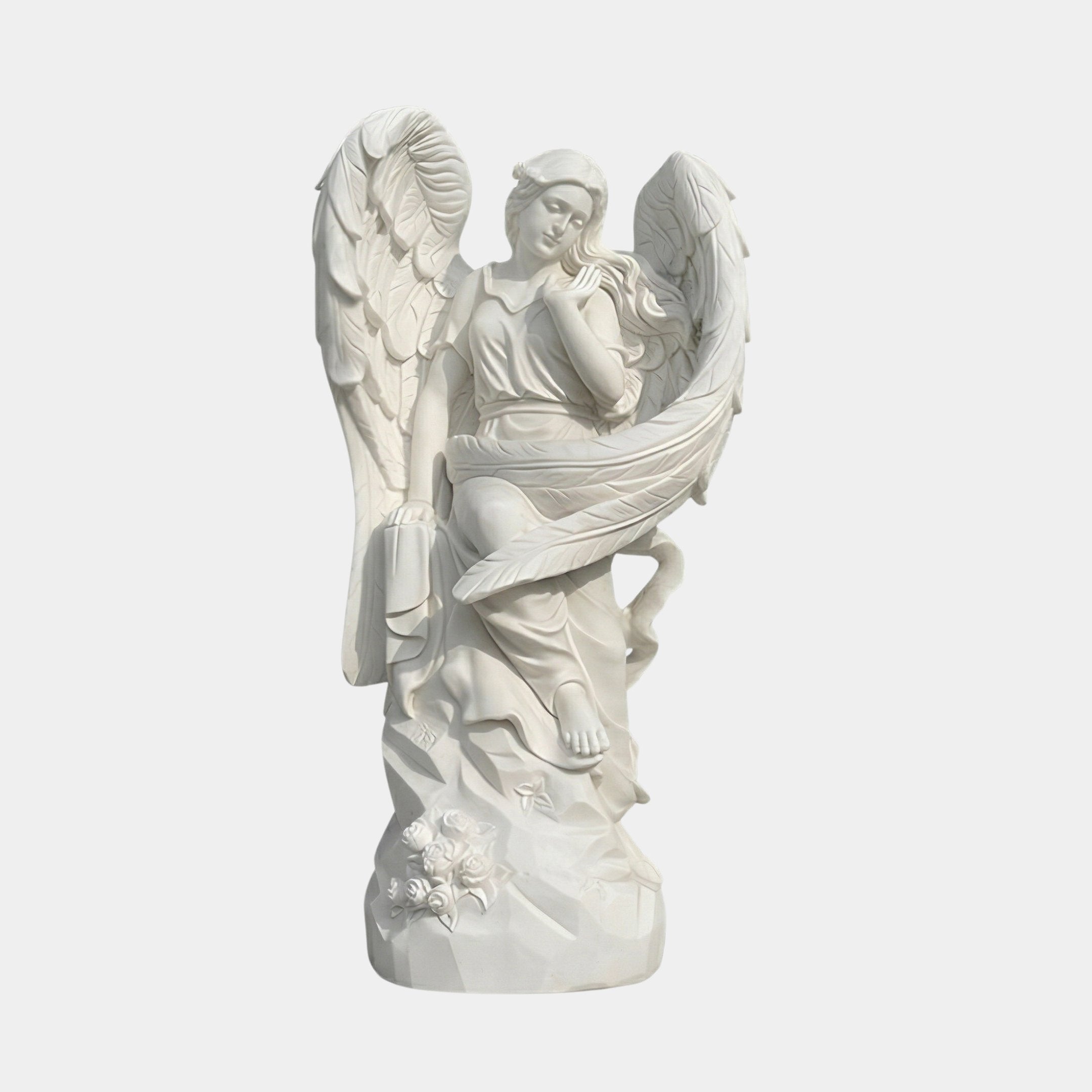 The Life-Size Angel Marble Outdoor Sculpture - 160cm by Giant Sculptures features a serene angel with large wings, seated on a rocky, flower-adorned base in white marble—perfect as an elegant outdoor centerpiece.