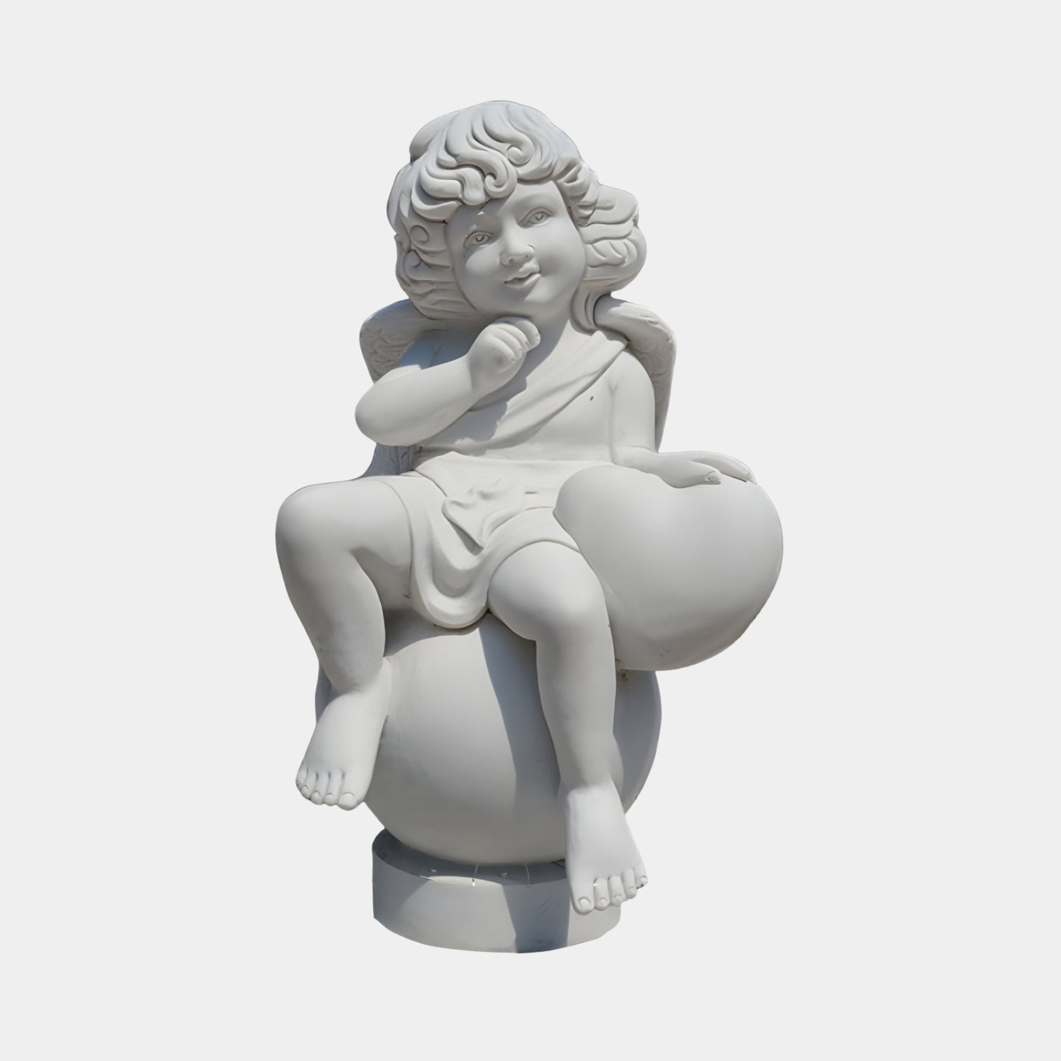 Cherub V4 Angel Marble Outdoor Sculpture by Giant Sculptures, 80cm white marble cherub seated on a sphere holding a heart, with curly hair and wings, on a plain light background.