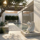 Kneeling Praying Angel Marble Outdoor Sculpture by Giant Sculptures in a courtyard setting beside a reflective pool, with white marble wings and flowing robes on a stone pedestal.