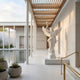 Giant Sculptures Goddess Liberty Angel Marble Outdoor Sculpture in white marble, 180cm, with outstretched wings and raised torch, displayed in a modern atrium beside a reflecting pool.