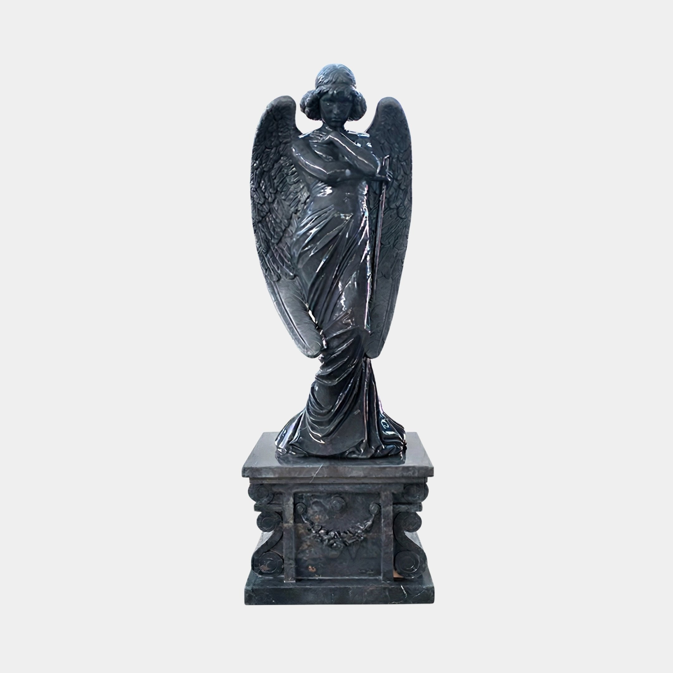 Black Angel Marble Outdoor Sculpture – 160cm by Giant Sculptures, depicting a winged angel in flowing robes with crossed arms on an ornate scrollwork pedestal, polished black marble with natural veining, shown against a plain light grey background.