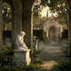 Eros Cupid Angel Marble Outdoor Sculpture by Giant Sculptures, 60cm white marble cherub in a seated pose on a stone pedestal, set in a lush garden cemetery with a chapel in the background.