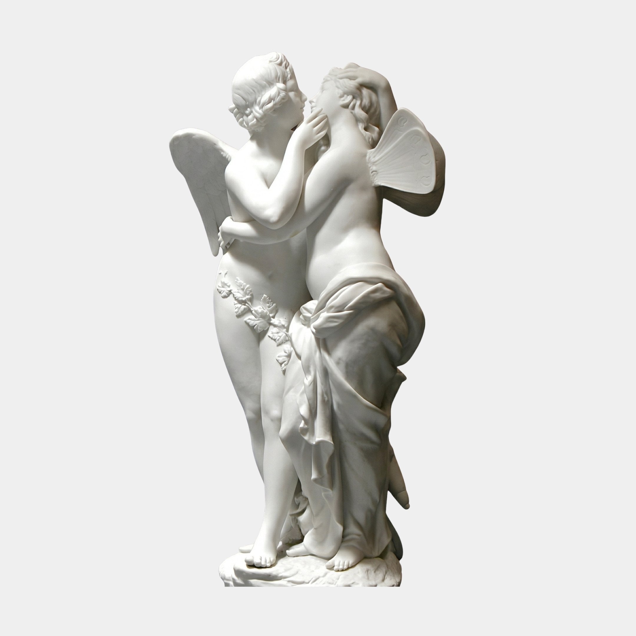 Cupid And Psyche Angel Marble Outdoor Sculpture by Giant Sculptures, depicting two intertwined winged figures in white natural marble on a round base, shown against a plain light background.