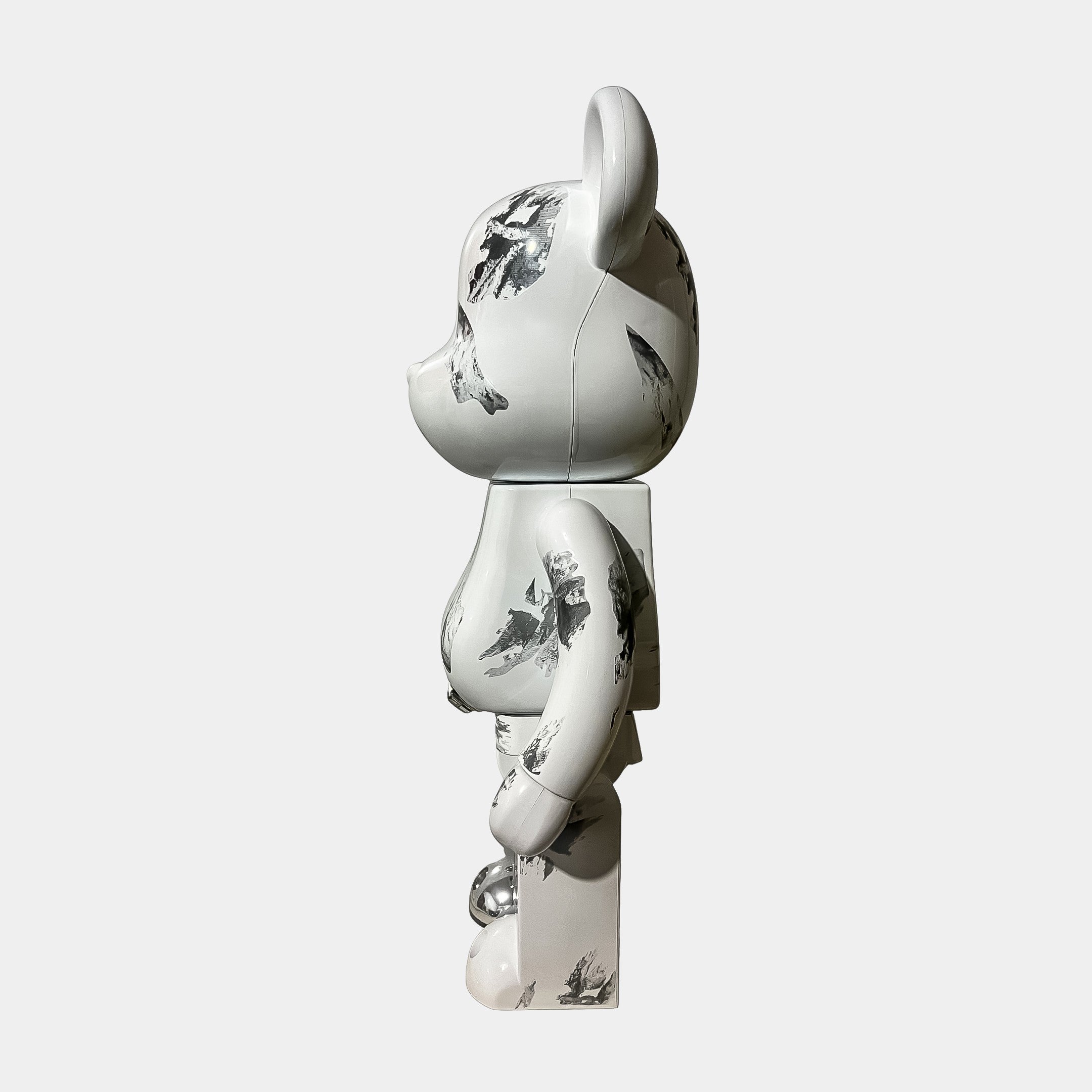 The Marble Chrome Bear Sculpture - 70cm by Giant Sculptures is a white resin bear statue in profile, decorated with abstract black and gray splatters for a modern marble effect.