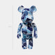The Giant Sculptures Sapphire Drift Bear Sculpture - 70cm features a glossy blue camouflage finish in various blue and white shades, displayed upright against a plain white background.