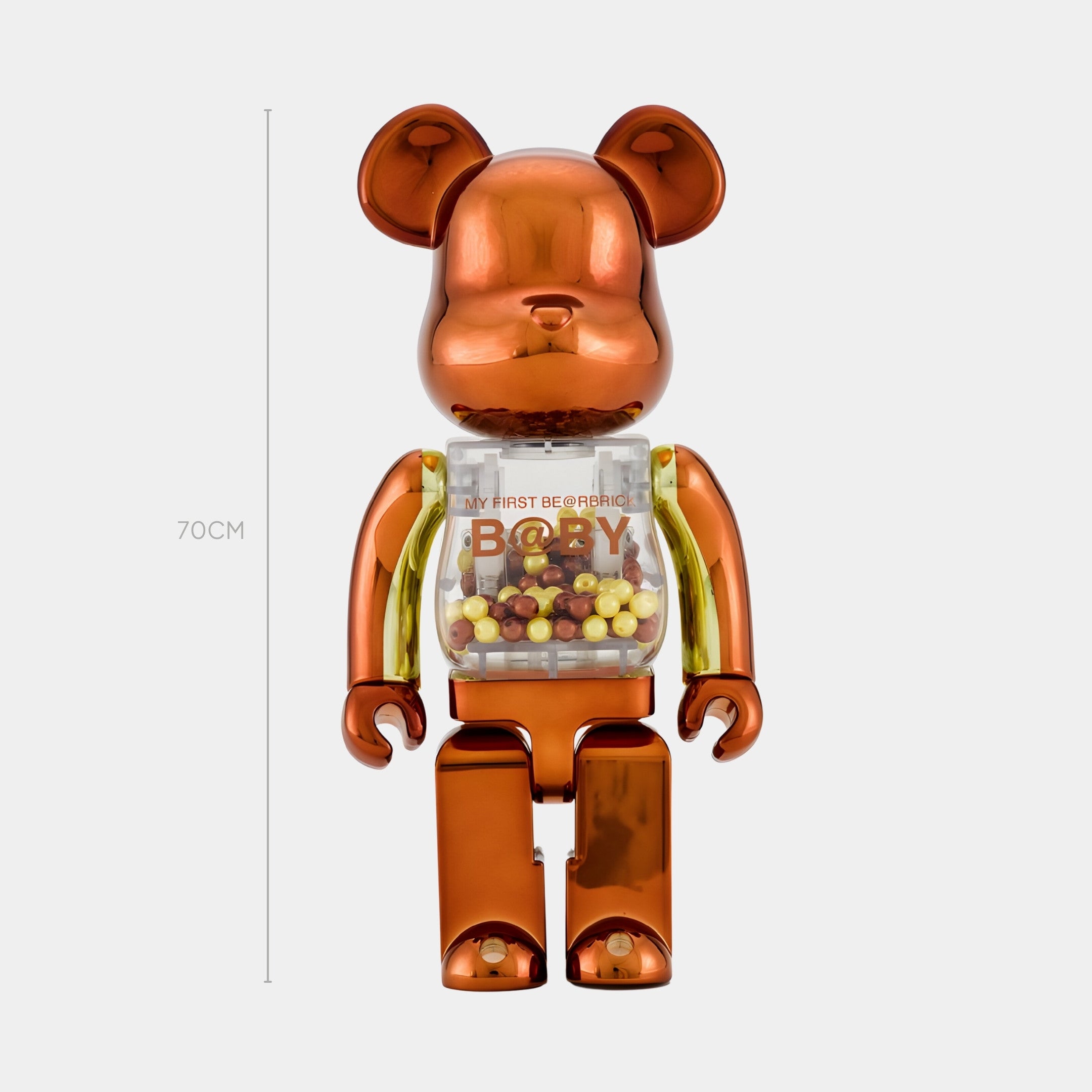 The Metallic Orange Beads Bear Sculpture by Giant Sculptures stands 70cm tall, featuring a shiny bronze and gold finish with a transparent torso filled with vibrant orange beads—an eye-catching contemporary art piece.