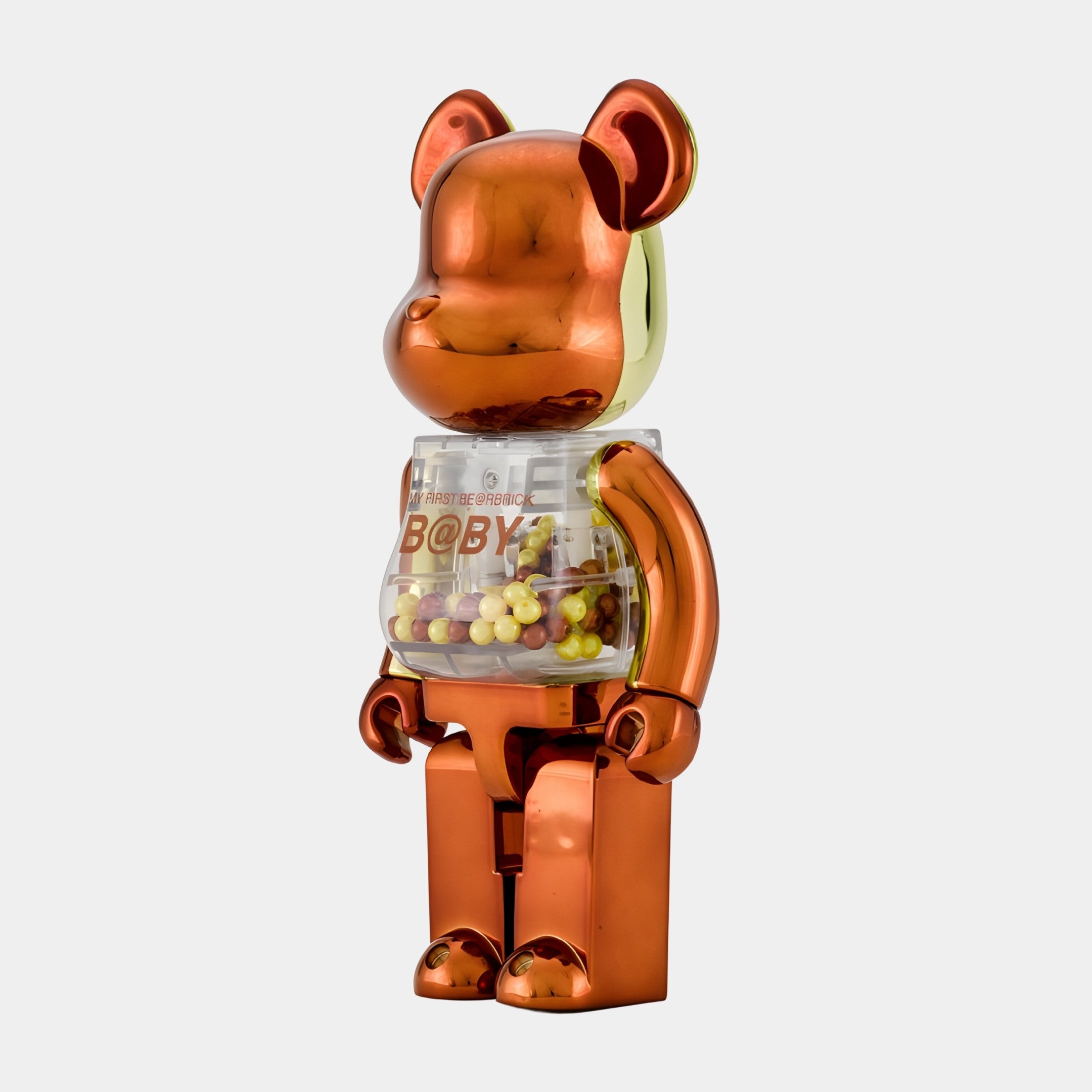 The Metallic Orange Beads Bear Sculpture (70cm) by Giant Sculptures stands upright against a white background, its shiny metallic form and transparent chest filled with colorful beads giving it a contemporary and playful vibe.