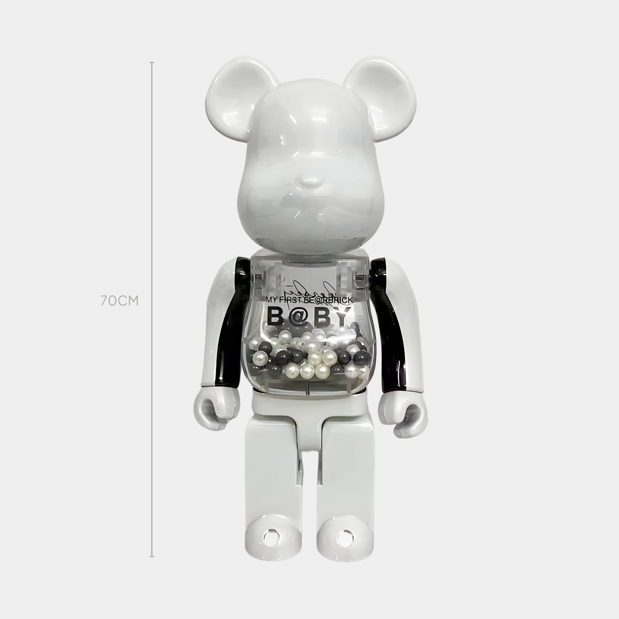 The Monochrome Beads I Bear Sculpture by Giant Sculptures stands 70cm tall, featuring a glossy white finish, black arms, and a transparent chest filled with monochrome beads.