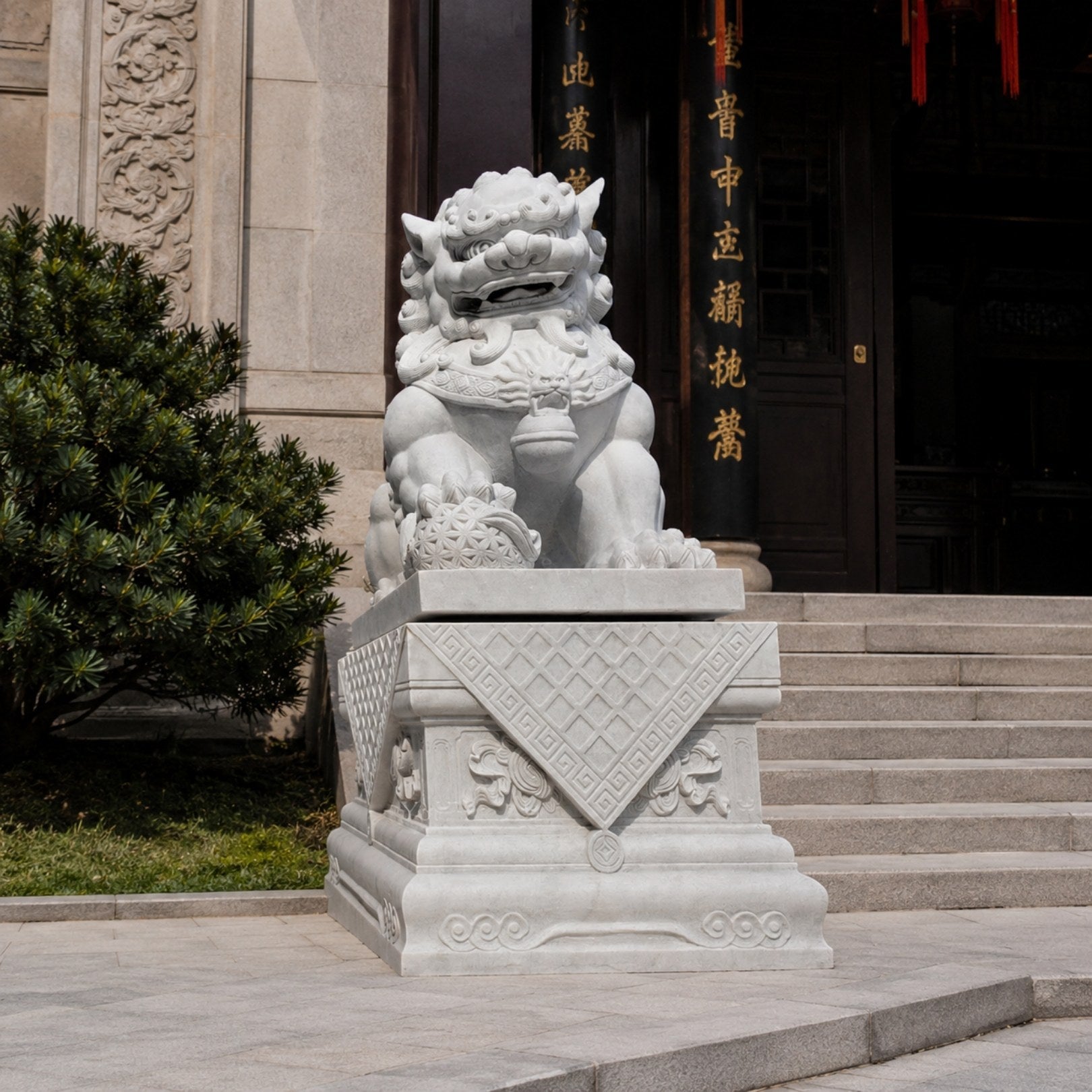 White marble guardian lion with an embroidered ball at a temple entrance