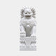 White marble Chinese guardian lion with one forepaw on an embroidered ball