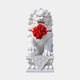 White marble guardian lion, a paw on a ball and a fabric rosette at its neck