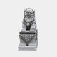 Marble Chinese guardian lion, paw on a cub, on a plinth with a dark cap slab