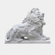 White marble lion lying at rest with its head raised and jaws closed, 120cm