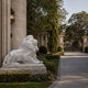 White marble lion resting with its jaws closed on its own slab