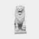 White marble lion seated frontally with one forepaw resting on a sphere