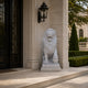 White marble lion seated with its forepaw on a sphere in a house porch