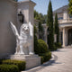 White marble winged lion on its stepped base beside a mansion drive