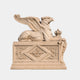 Beige stone griffin couchant with eagle head and raised wings, one paw on a crown