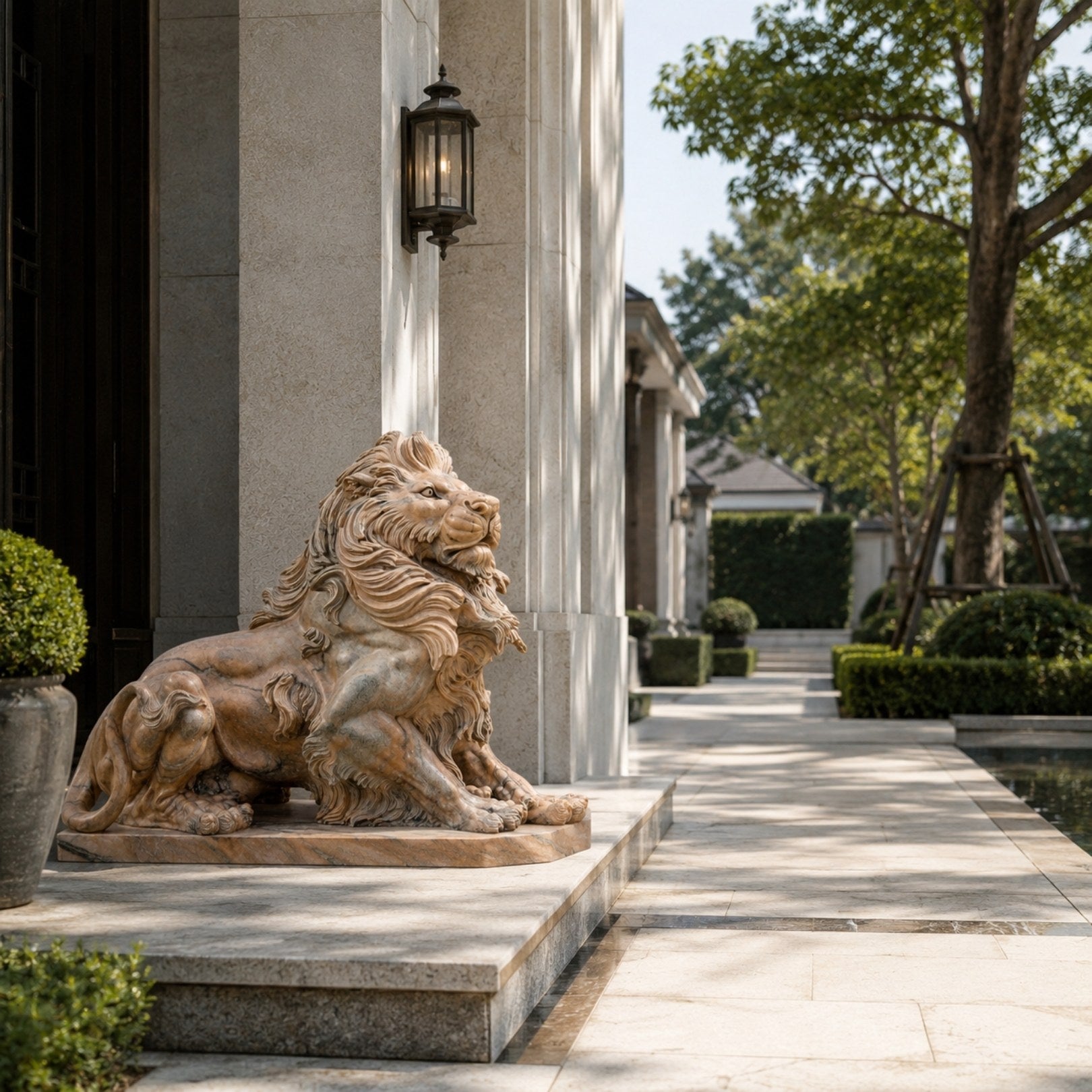 Pink marble lion couchant with its jaws parted on its matching slab