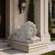 White marble lion couchant with its forepaws over the edge of the slab