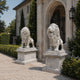 The two marble lions on their moulded pedestals flanking a gateway