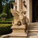 The beige marble griffin on its fluted pedestal beside a stone entrance