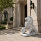 White marble lion looking up with a forepaw on its sphere
