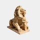 Honey-amber marble lion couchant on a thick slab, head lifted and turned out