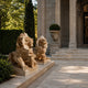 The two couchant honey marble lions on a terrace beside stone steps