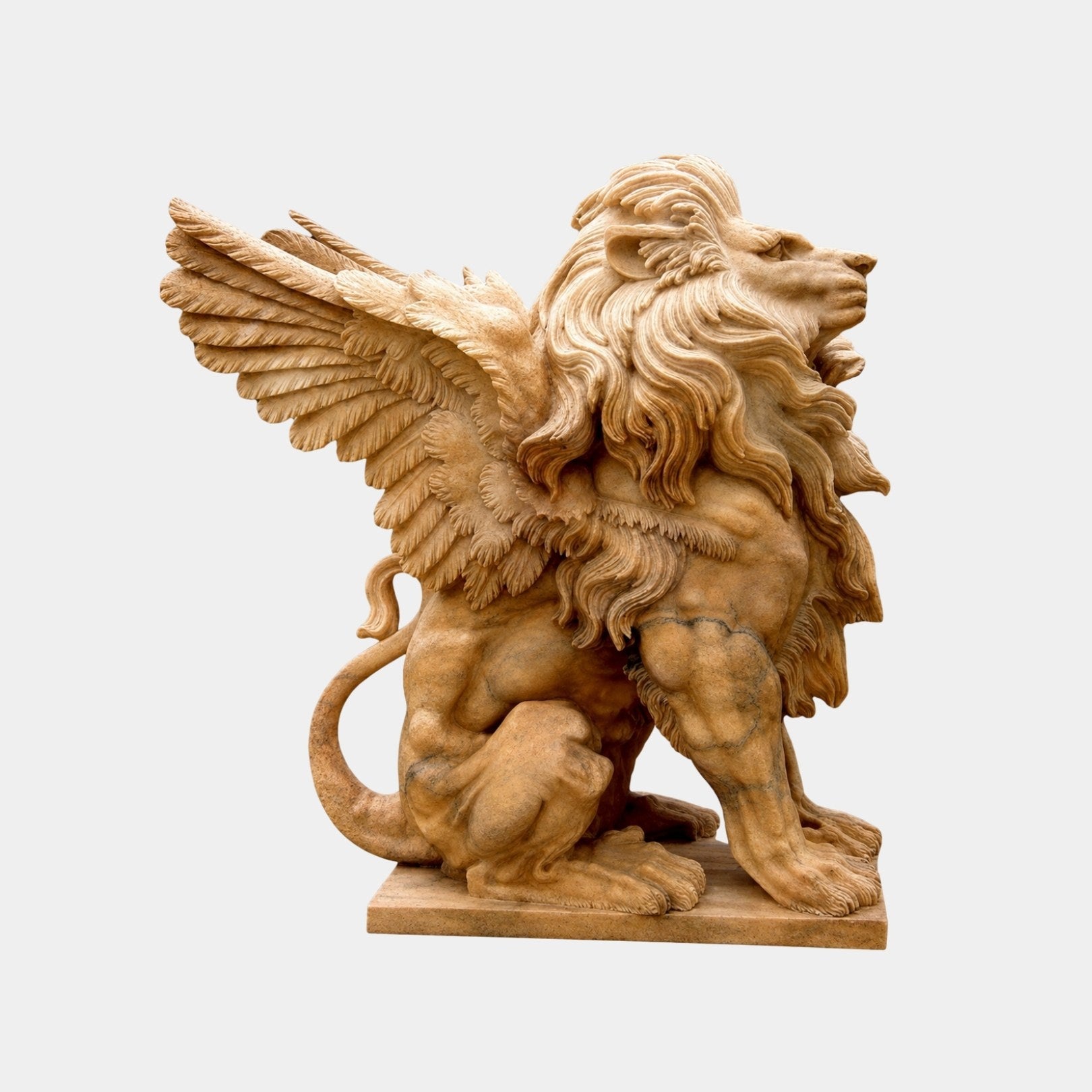 Honey marble winged lion seated with both wings raised and swept back