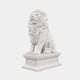Bright white marble lion seated on a leaf-moulded pedestal