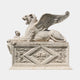 Buff stone winged lion couchant with a raised wing and a crown at its paw