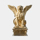Beige stone winged lion seated frontally with both wings raised