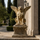 Beige stone winged lion seated on its carved capital