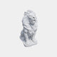 White marble lion seated with head raised on an irregular slab