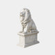 White marble lion seated and roaring on a gadrooned pedestal