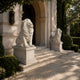 White marble lion roaring on its gadrooned pedestal