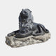 Black marble lion couchant on a rough pale grey rock base